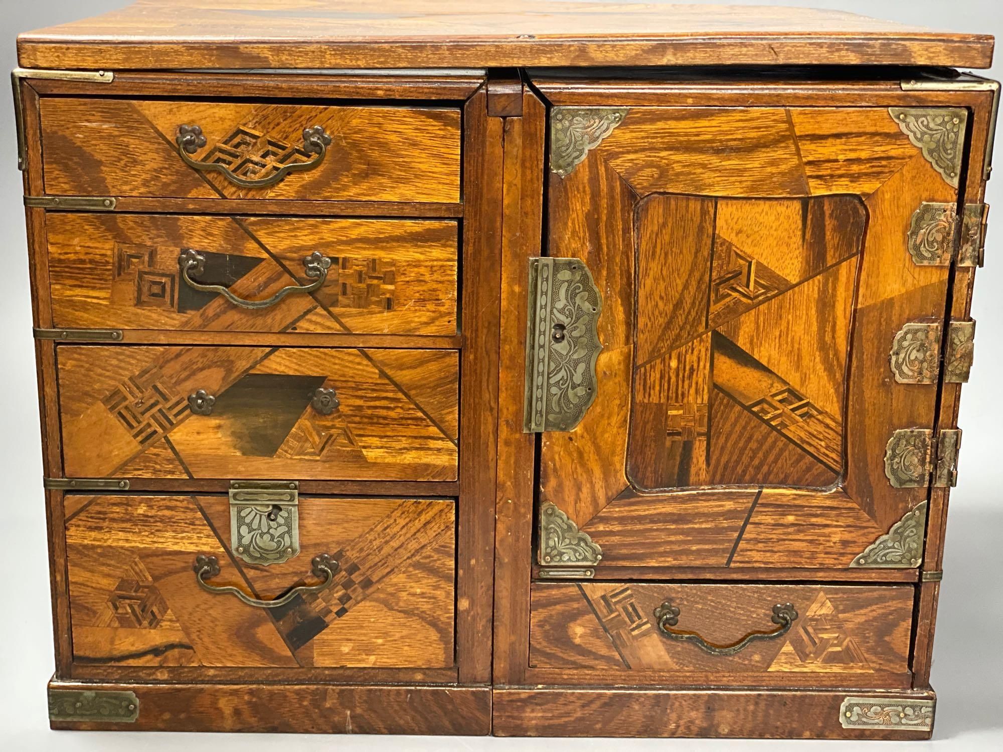 A Japanese metal mounted inlaid elm box with drawers, length 36cm